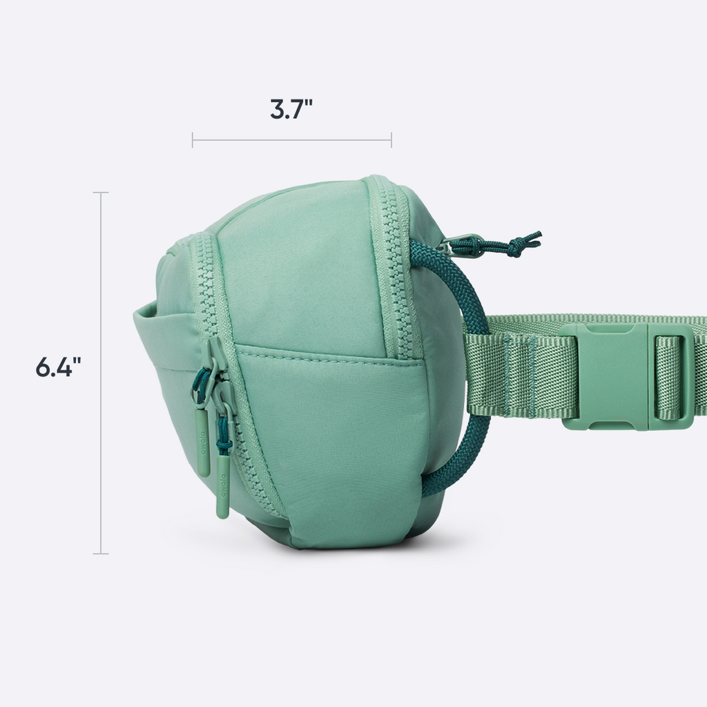 Owala All-Day Crossbody in Sea Glass, light blue ripstop body unzipped to show internal split mesh pocket holding cards and small essentials, with text reading "smart storage with split mesh pocket"